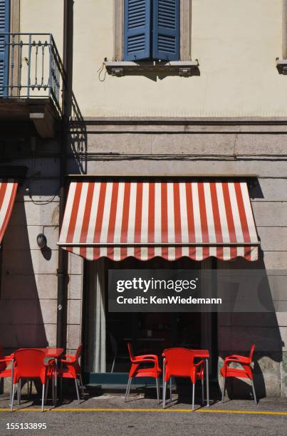 cafe beneath the red awning - awning stock pictures, royalty-free photos & images