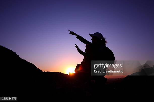 mother and son against the sunset. - summit love courage stock pictures, royalty-free photos & images