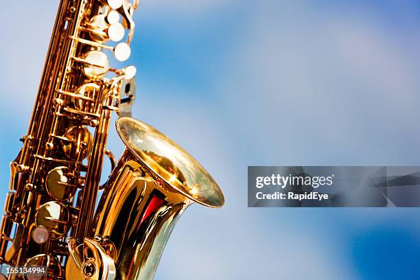 alto sax close up against sky with scattered clouds - new orleans music stock pictures, royalty-free photos & images