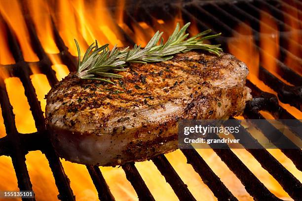 grilled pork chops in flames - broiling stock pictures, royalty-free photos & images