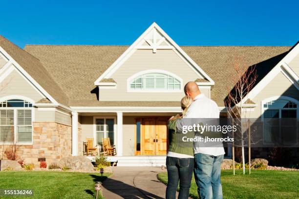 young couple admiring their new home - admiration stock pictures, royalty-free photos & images