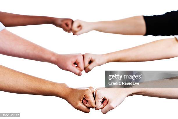 six hands greet by bumping fists - fist bump stock pictures, royalty-free photos & images