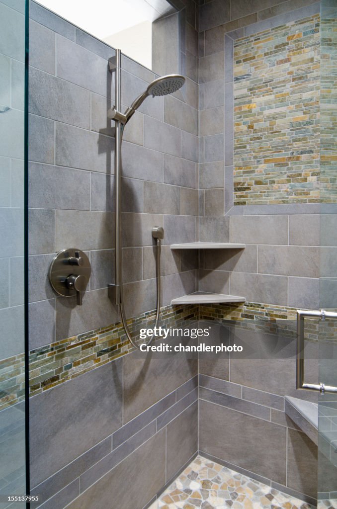 Modern shower done in pebbles and tile