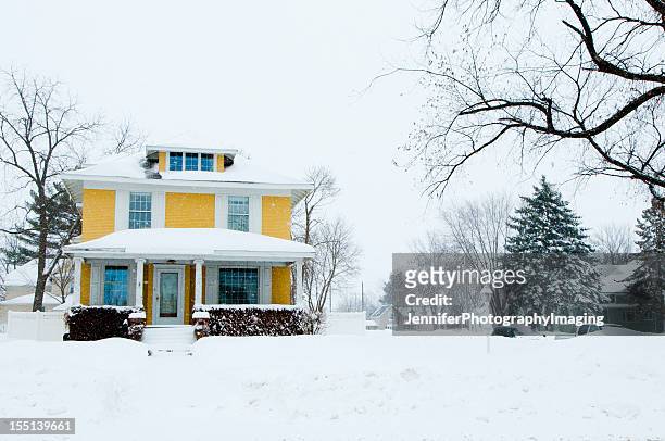 traditional home in a snow storm - wisconsin v iowa stock pictures, royalty-free photos & images