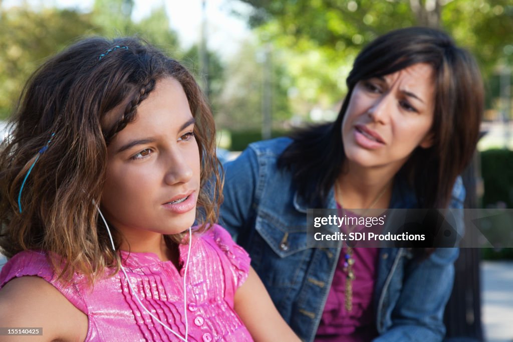 Mother trying to talk with turned-off teenager