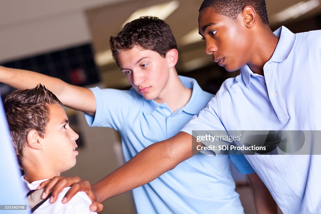 High school boys bullying a smaller student