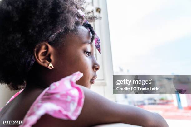 girl contemplating looking away at home - caribbean dream stock pictures, royalty-free photos & images