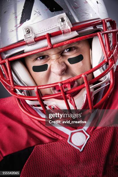 intense little league football portrait - american football lineman stock pictures, royalty-free photos & images