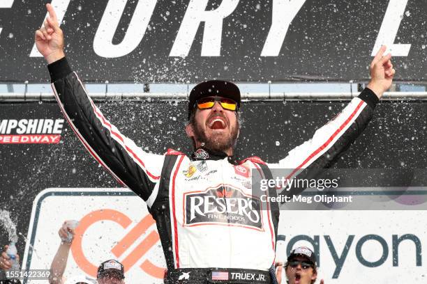 Martin Truex Jr., driver of the Reser's Fine Foods Toyota, celebrates in victory lane after winning the NASCAR Cup Series Crayon 301 at New Hampshire...