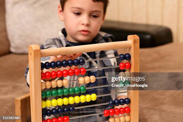 boy with abacus - autism stock pictures, royalty-free photos & images