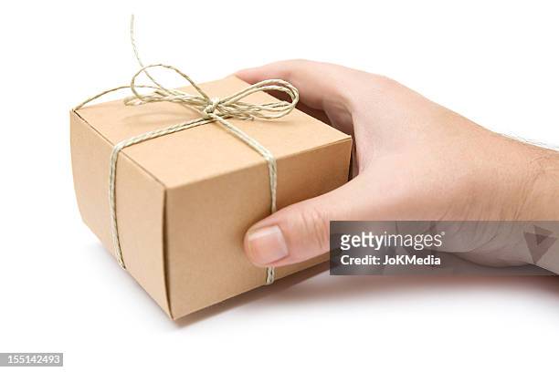 segurando uma pequena decorada de pacote - guy isolated holding a small box in his hand imagens e fotografias de stock