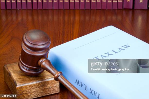 book of tax law on wooden table - tax law stock pictures, royalty-free photos & images