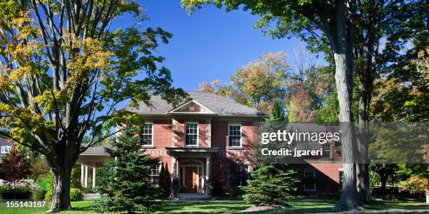 a beautiful two story estate home. - stone house garden stock pictures, royalty-free photos & images