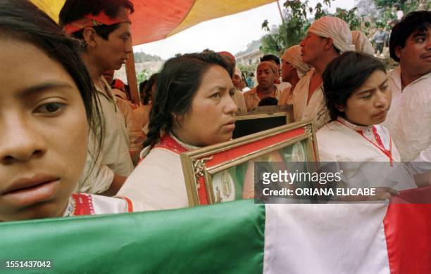 Indigenous people people of Chiapas celebrate the Virgin of Guadalupe. Indigenas tzotziles sostienen una bandera de Mexico y un cadro con la Virgen...