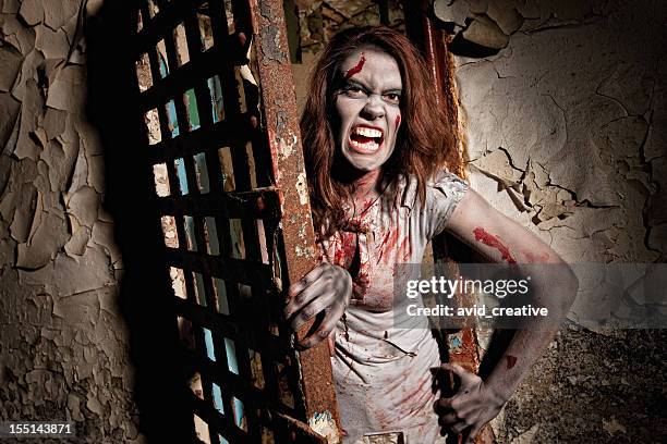 zombie coming out of jail cell door - woman prison stock pictures, royalty-free photos & images