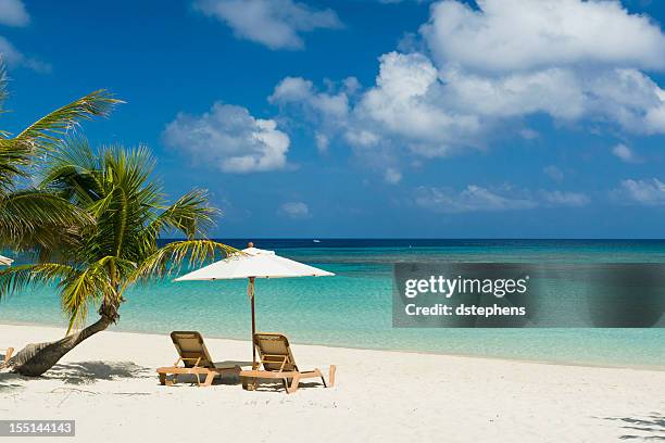 chairs on beach - beach umbrella sand stockfoto's en -beelden