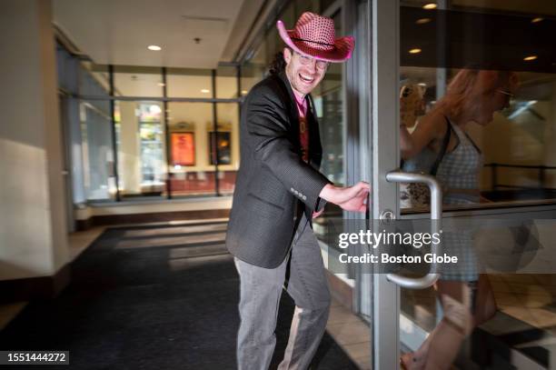 Man smiles as he enters the theater before the first night of the screening of the "Barbie" movie at the AMC movie theater at Boston Common.