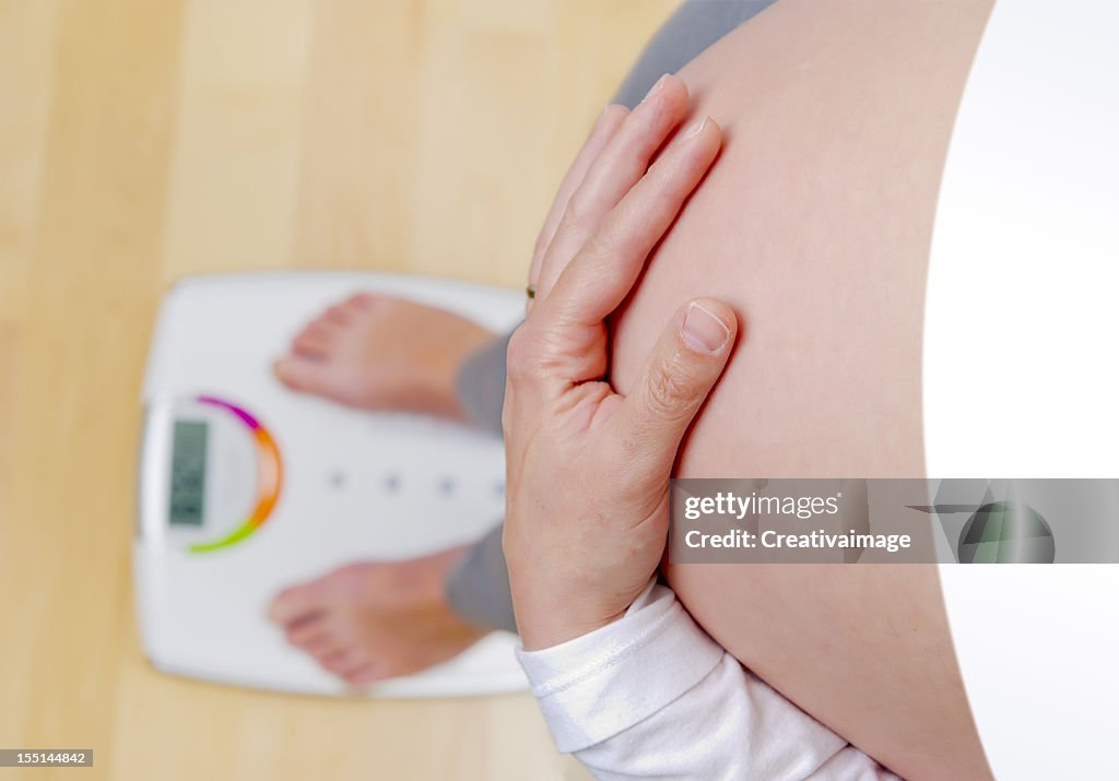 Pregnant woman on the balance