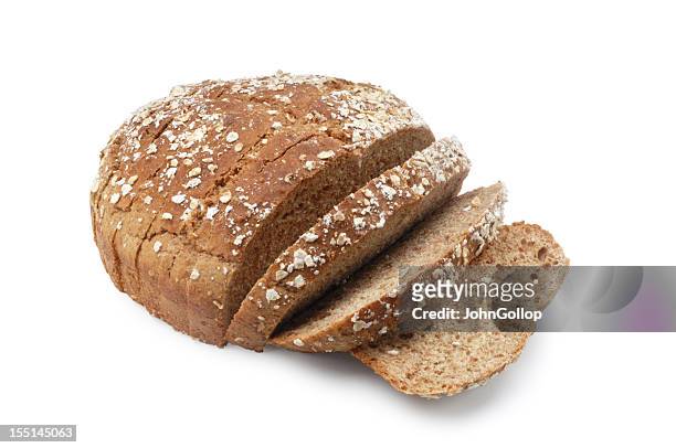 a loaf of brown sesame seed bread with three slices cut - bread bildbanksfoton och bilder