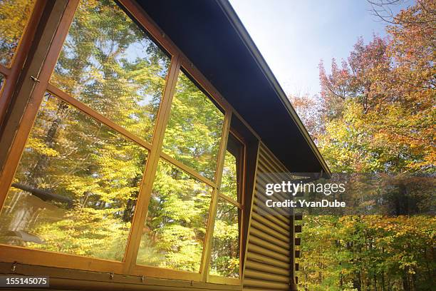 log cabin window reflection - eastern townships quebec stock pictures, royalty-free photos & images