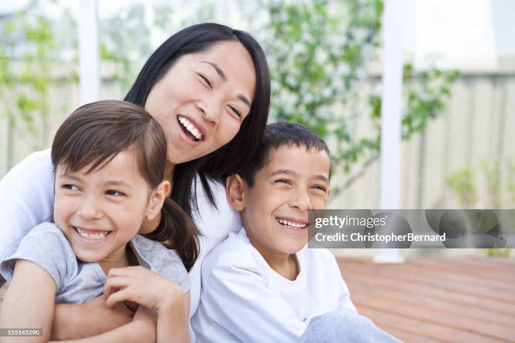 Mother and children sitting on deck