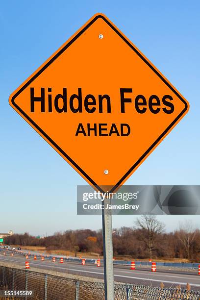 hidden fees ahead highway sign - fees stock pictures, royalty-free photos & images