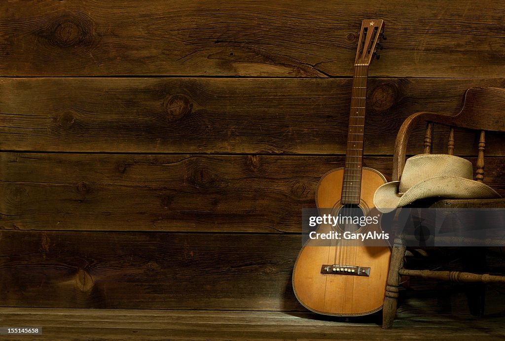 Country and Western Music scene w/chair,hat,guitar-barnwood background