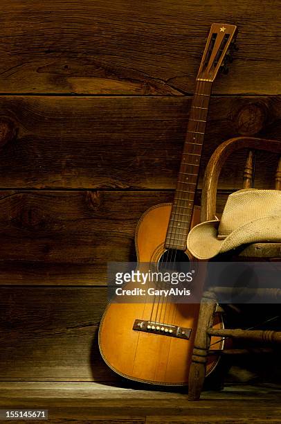 country and western scene w/ guitar,chair,cowboy hat-barnwood background - country and western music stockfoto's en -beelden