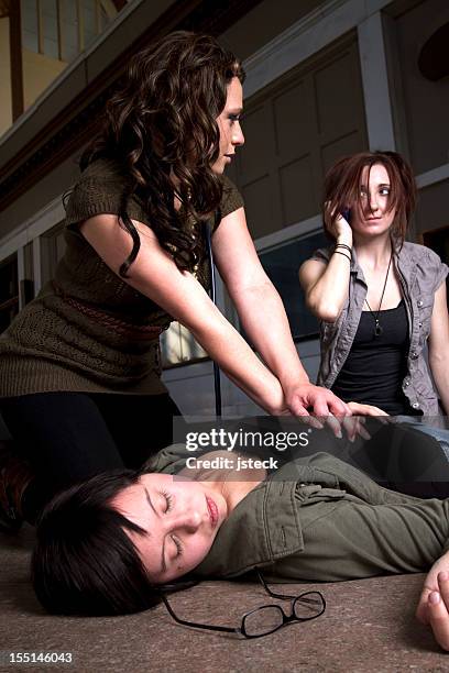 woman performing cpr on an unconscious woman - unconscious person stock pictures, royalty-free photos & images