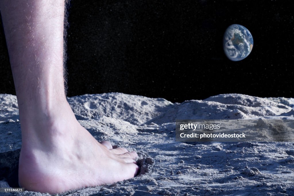Human naked foot on moon's surface