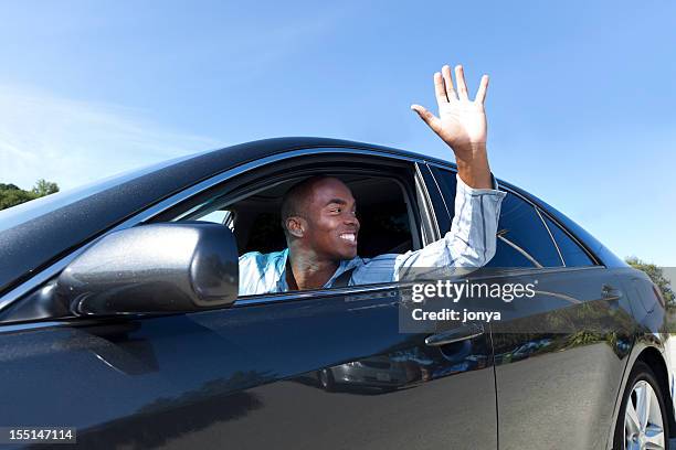 a happy young man driving and waving - hand open window stock pictures, royalty-free photos & images