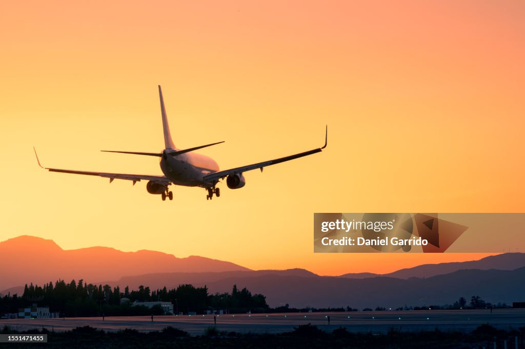 Epic landing with the sunset and the mountains, plane landing beneath a breathtaking sunset, sunset landing
