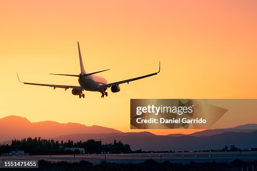 Epic landing with the sunset and the mountains, plane landing beneath a breathtaking sunset, sunset landing