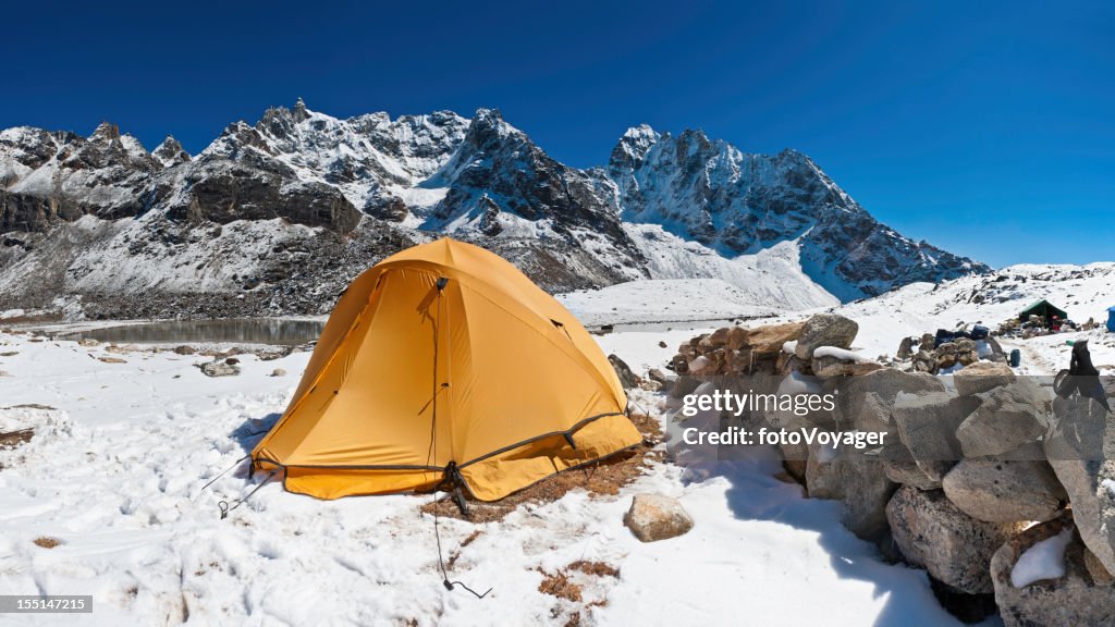 Yellow dome tent high mountain camp snow summits Himalayas Nepal