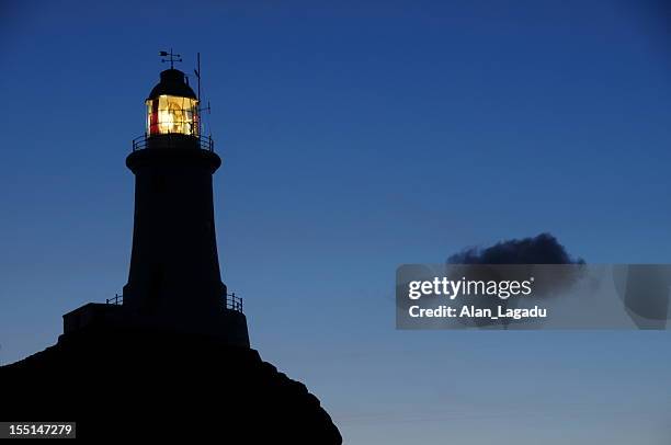 corbiere lighthouse, jersey. - lighthouse in silhouette stock pictures, royalty-free photos & images