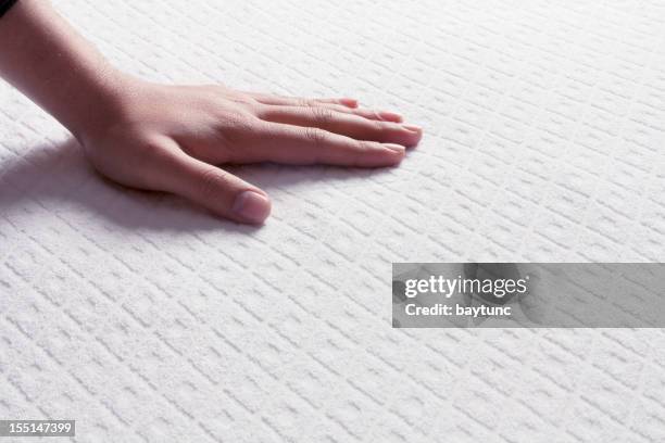 mattresses on the human hand - mattress stock pictures, royalty-free photos & images