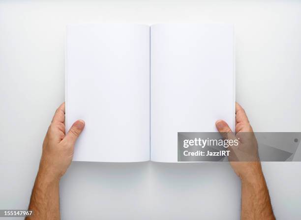two hands holding open a blank magazine - blank pages in open book overhead view stock pictures, royalty-free photos & images