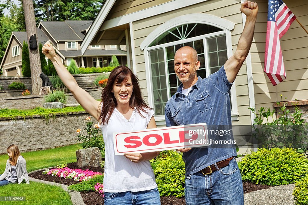 Happy Married Couple with Sold Home