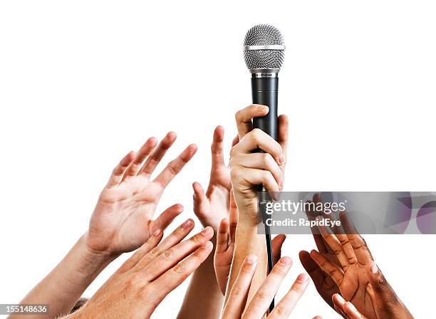 i want to be an idol: many hands grabbing microphone - holding microphone stock pictures, royalty-free photos & images