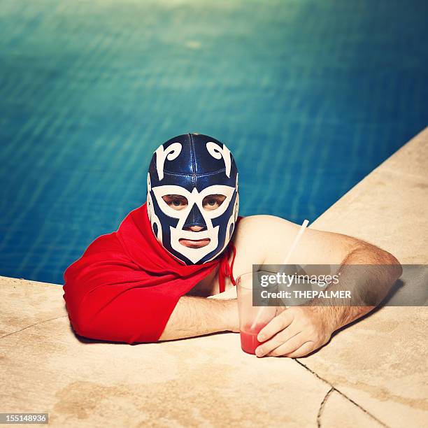 mexican luchador by the pool - sportmasker stockfoto's en -beelden