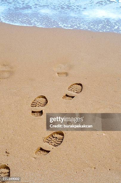 footprints on the sand near waves, north cyprus - sand trap stockfoto's en -beelden