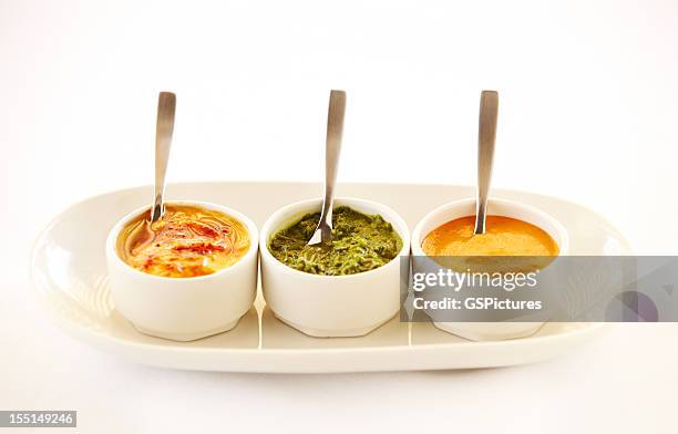 three bowls of different dips in a row - sauce stockfoto's en -beelden