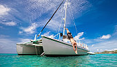 Tropical Vacation: Man Diving Off Sailboat