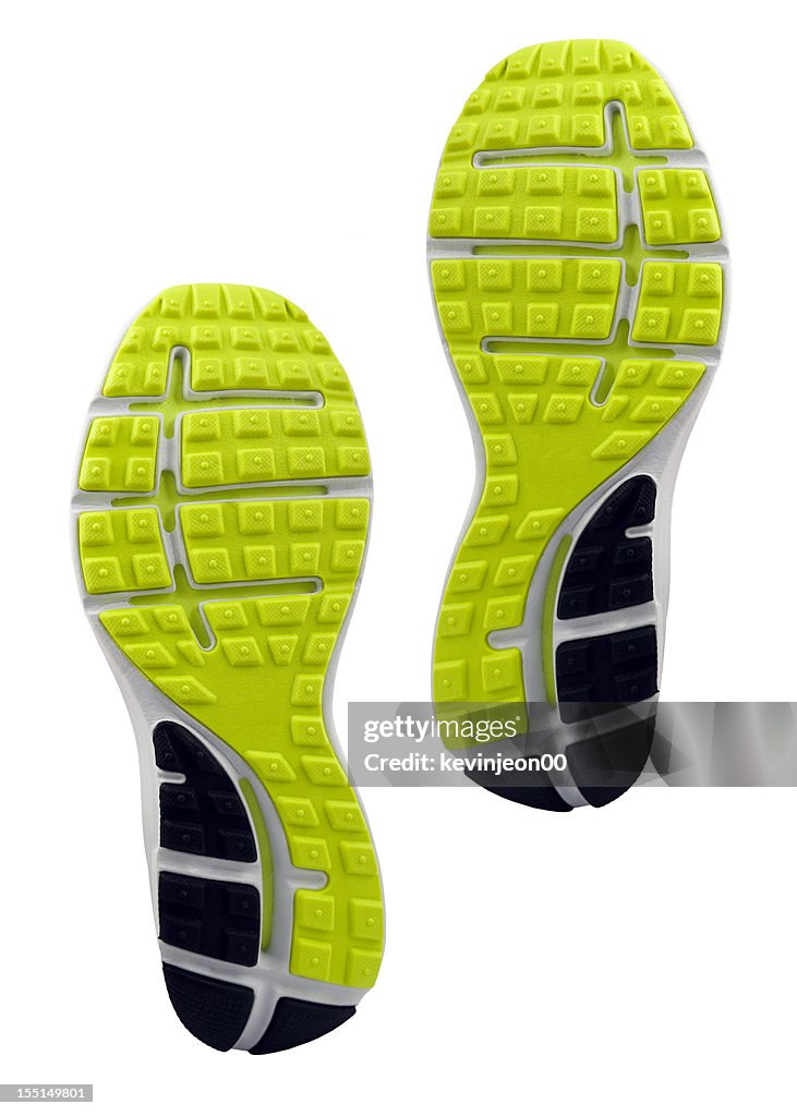Yellow and black treaded soles of athletic shoes