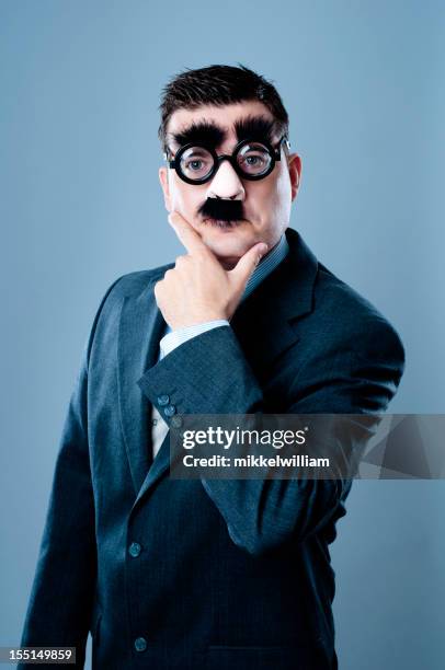 business person with fake nose and mustache - groucho marx disguise stock pictures, royalty-free photos & images