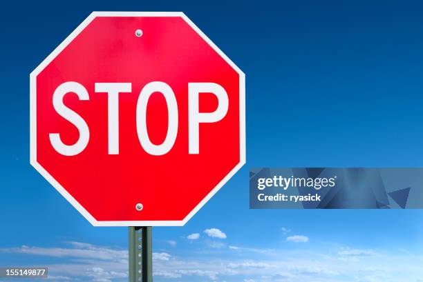 stop sign post over a blue sky background - stoppskylt bildbanksfoton och bilder