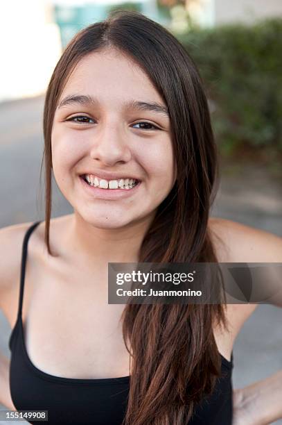 smiling thirteen years old hispanic girl - 14 15 years stockfoto's en -beelden