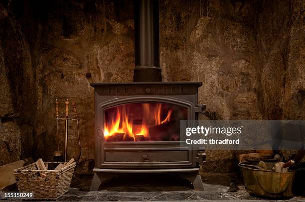 cozy fireplace with a wood burning stove - burning wood stock pictures, royalty-free photos & images