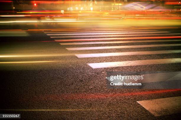 zebra crossing at night - long exposure light trails stock pictures, royalty-free photos & images