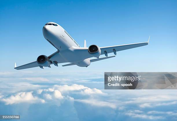 passenger jet airplane flying above clouds - flying stock pictures, royalty-free photos & images